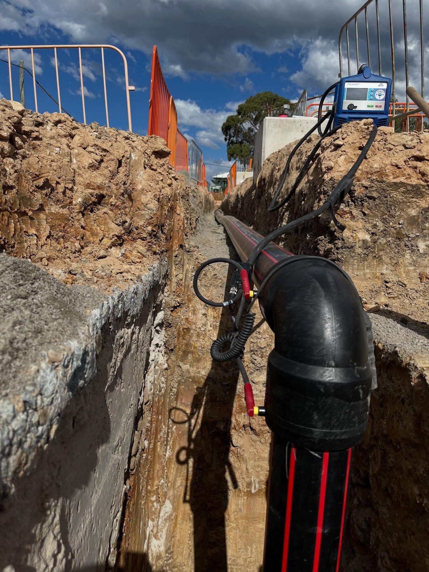 HDPE pipework and electrofusion equipment in a prepared service trench